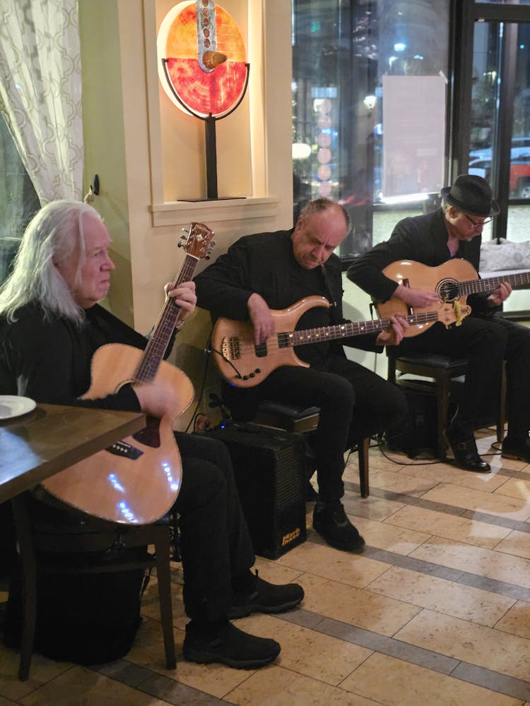 a group of people sitting at a guitar