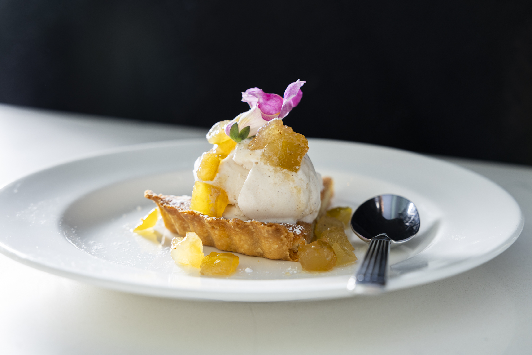 a flower sits in a piece of cake on a plate