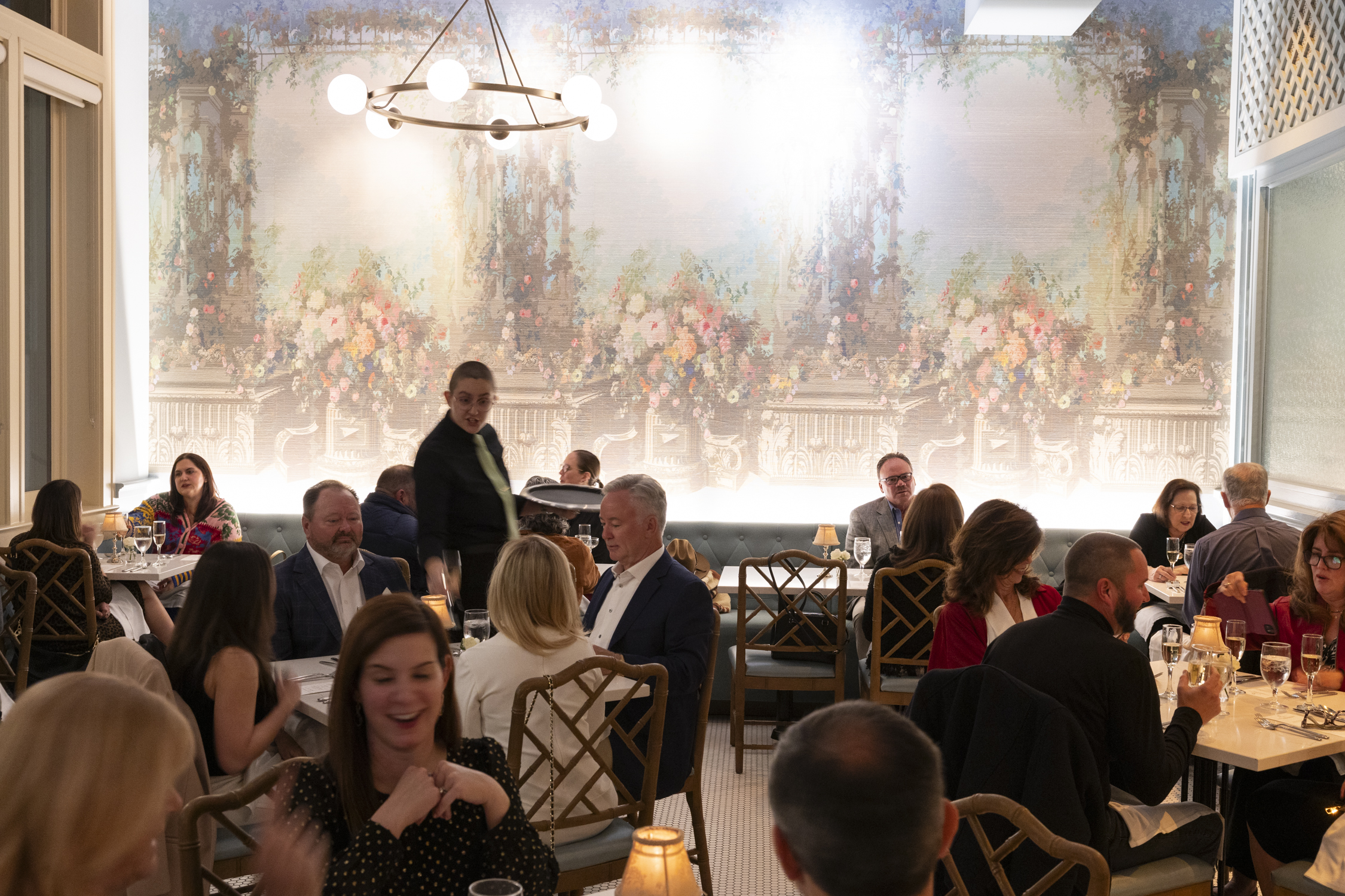a group of people sitting at a table in a restaurant