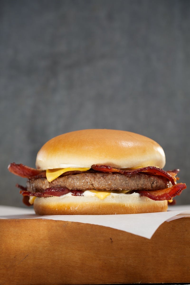 a close up of a hamburger on top a napkin