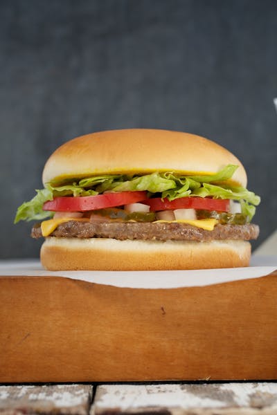 a close up of a hamburger on top a napkin