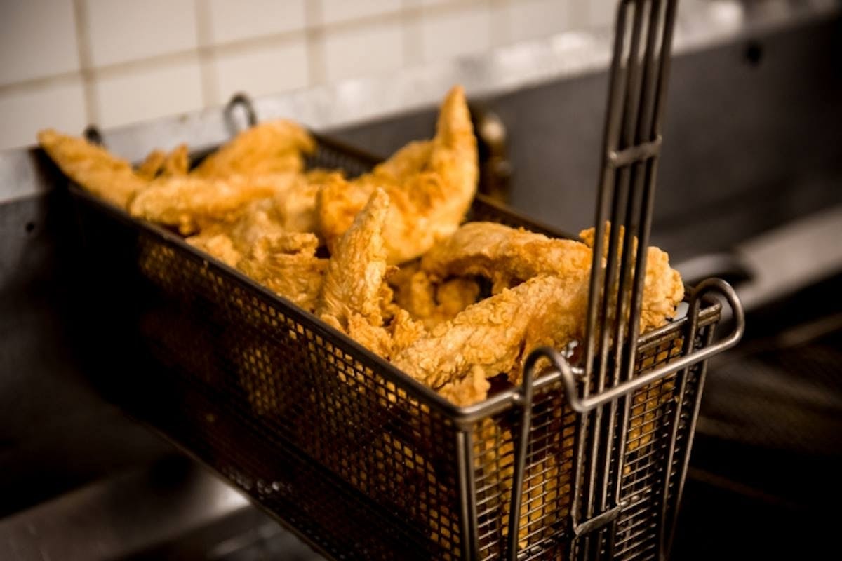 hand-breaded chicken tenders over a fryer