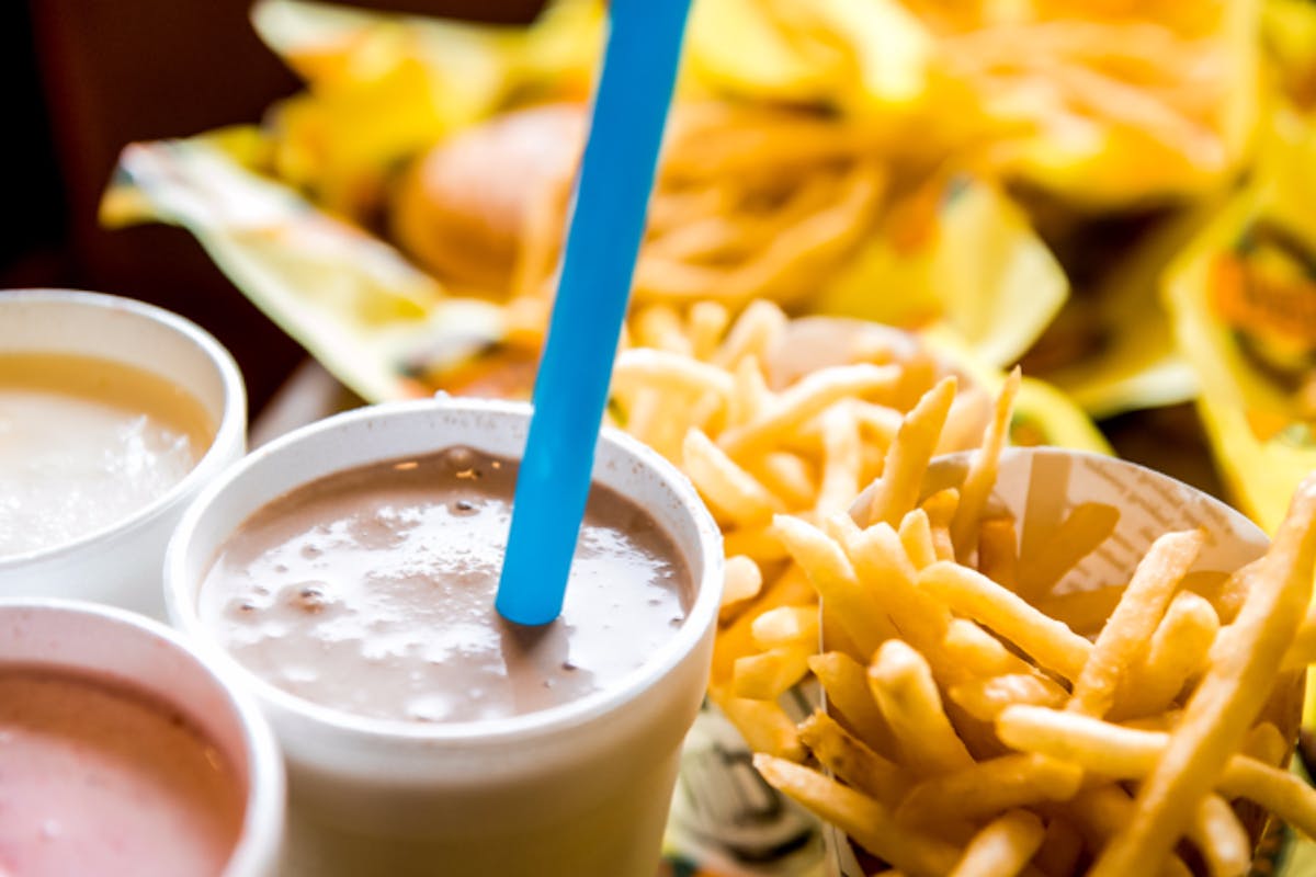 french fries next to a cup of coffee