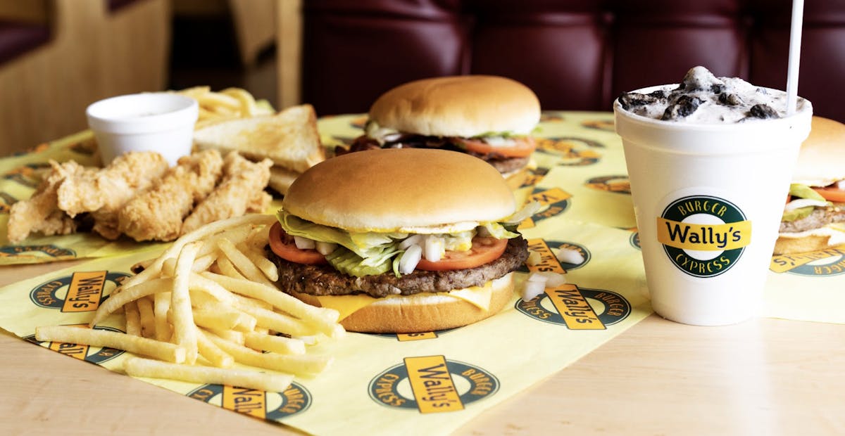 a table topped with a sandwich and fries on a plate