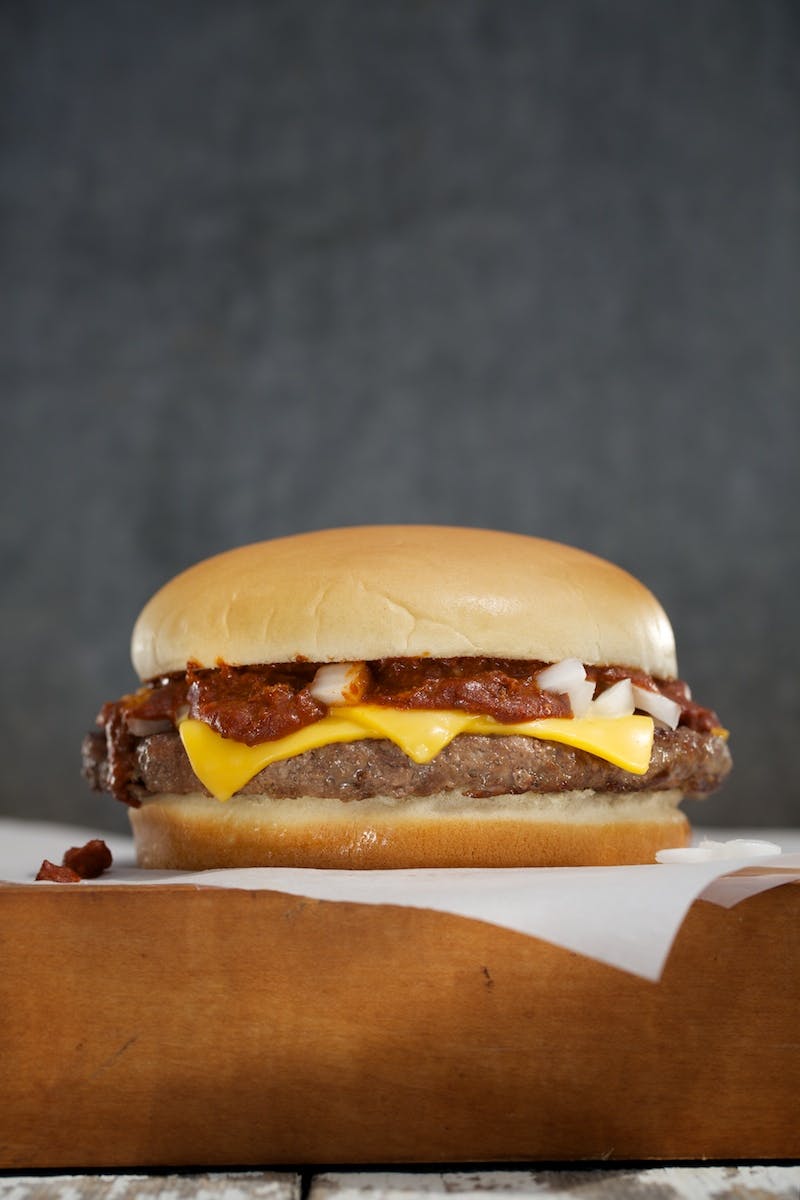 a close up of a hamburger on top a napkin