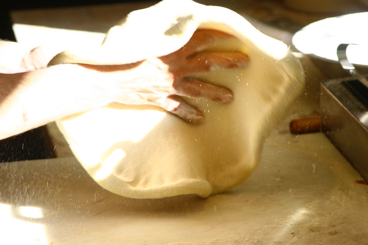 a hand preparing a dough 
