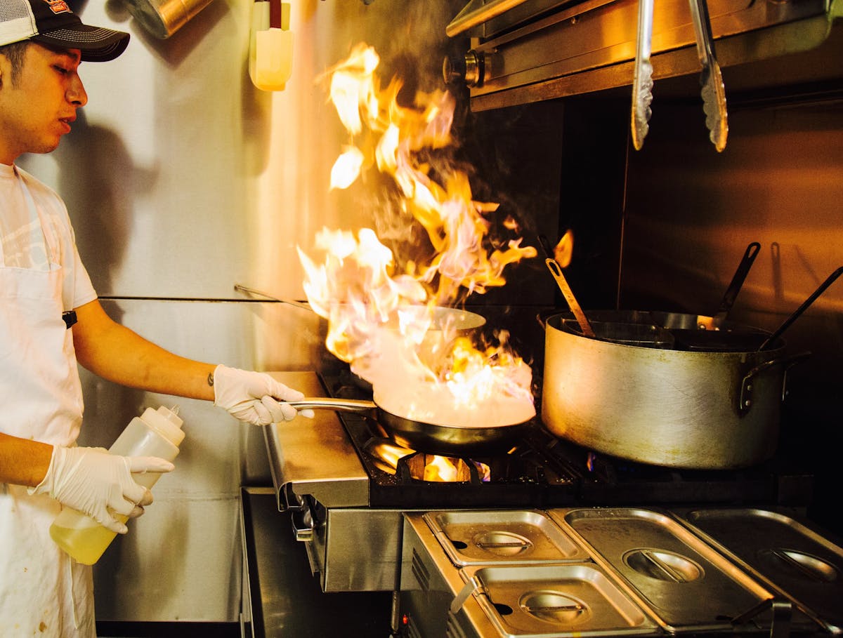 a man cooking food on a stove