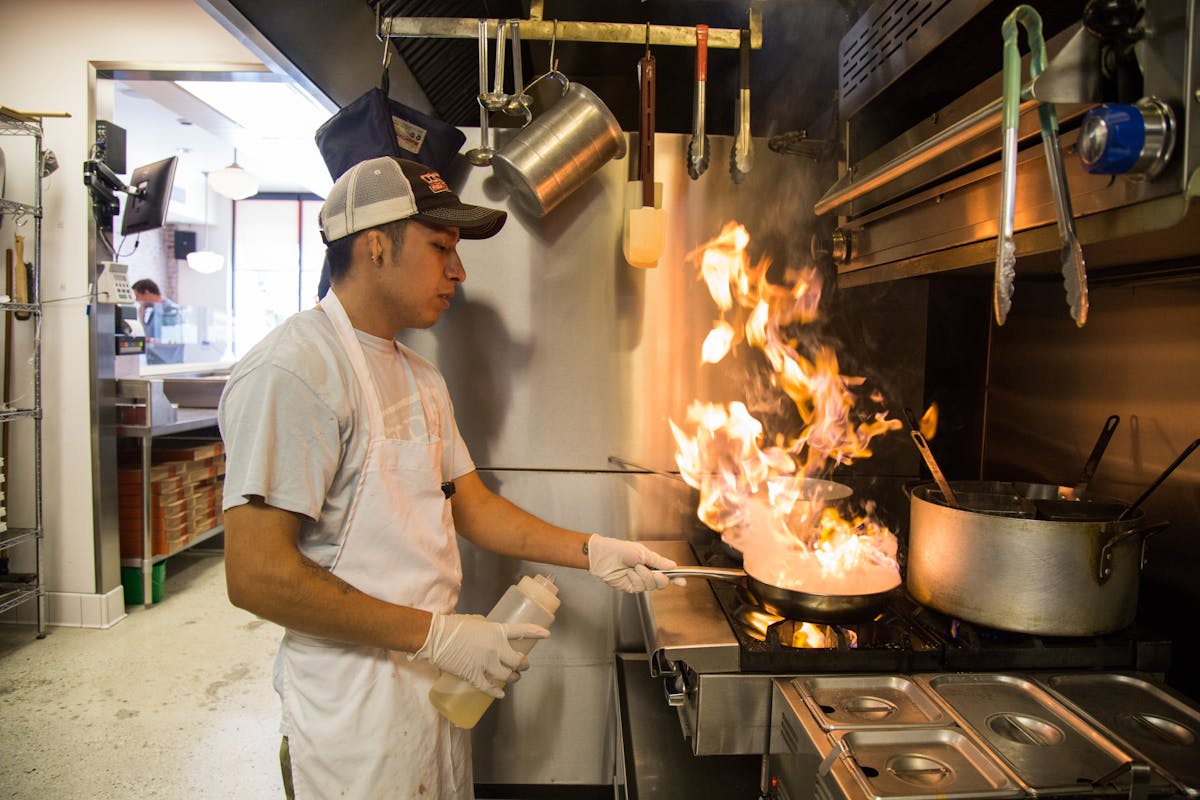 a man cooking in a kitchen preparing food