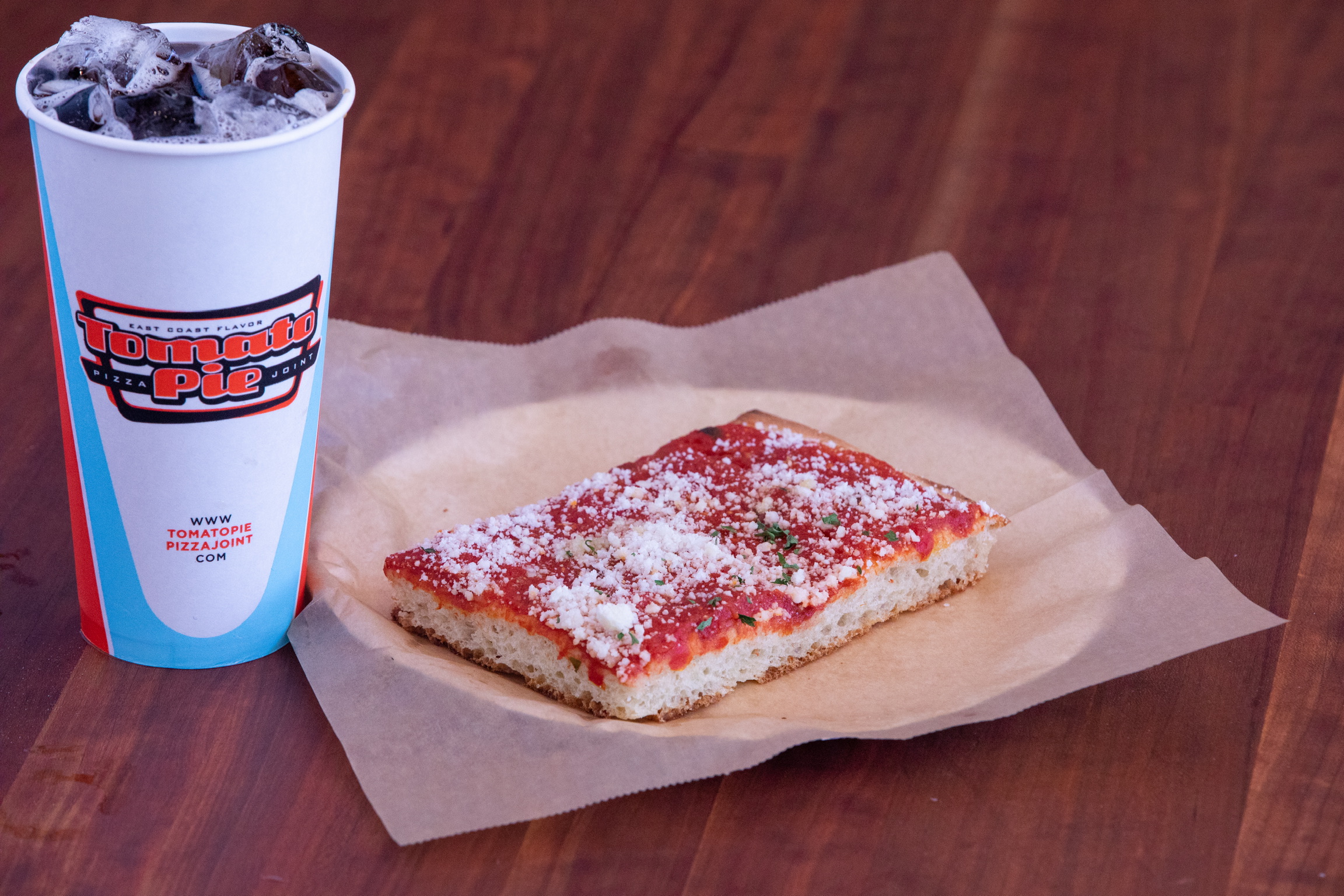 a cup of coffee sitting on top of a wooden table
