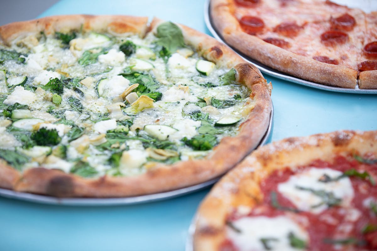 a pizza sitting on top of a plate of food