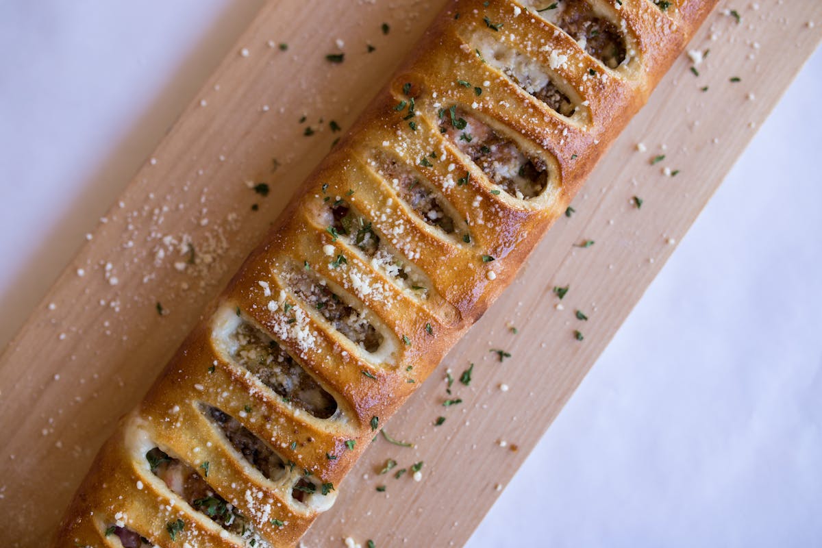 a close up of a long subway style sandwich