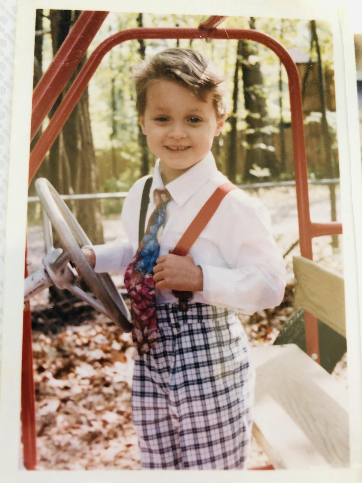 a boy wearing a suit and tie