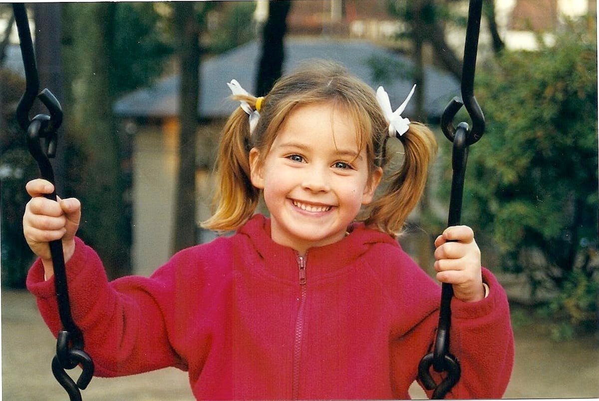 a little girl holding a baseball bat