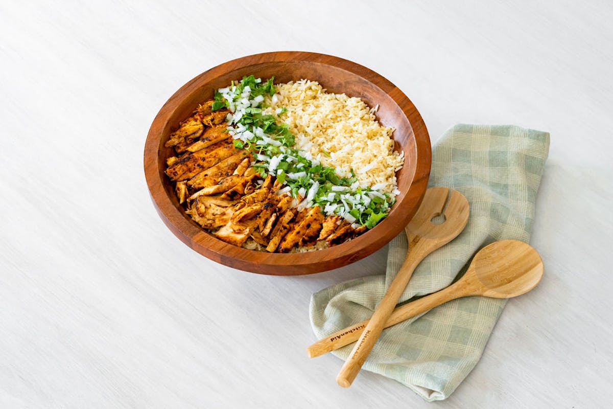 a bowl of food sitting on top of a wooden table