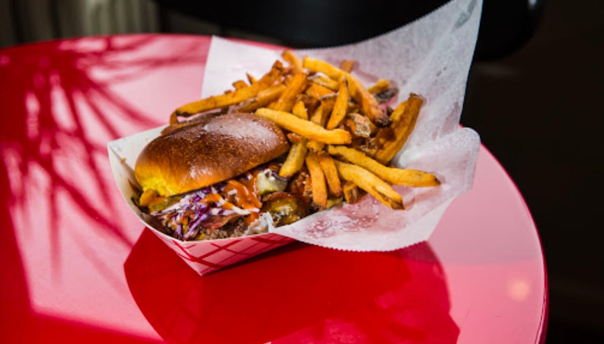 a basket of fries and a sandwich on a plate