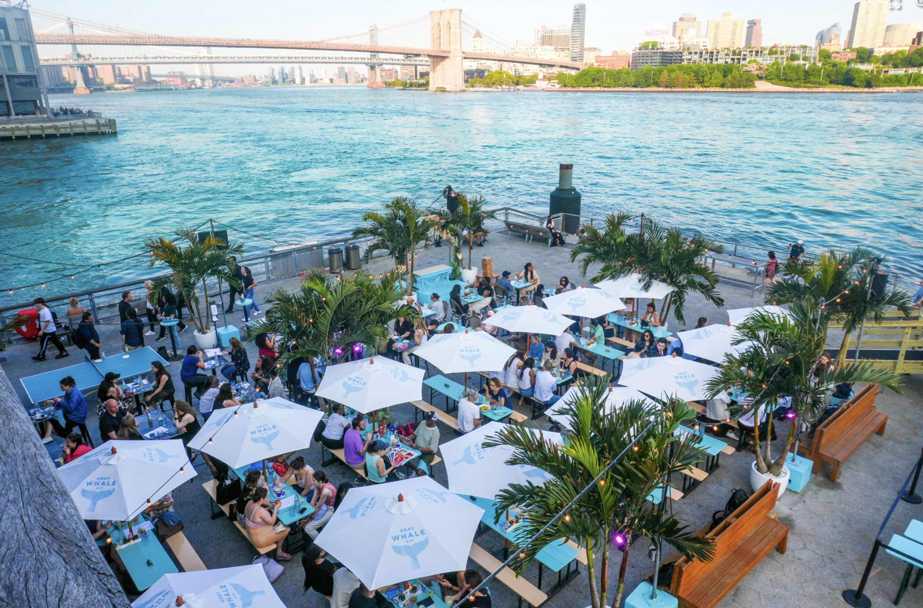 Watermark Beach at Pier 15 with festive waterfront seating and tropical decor
