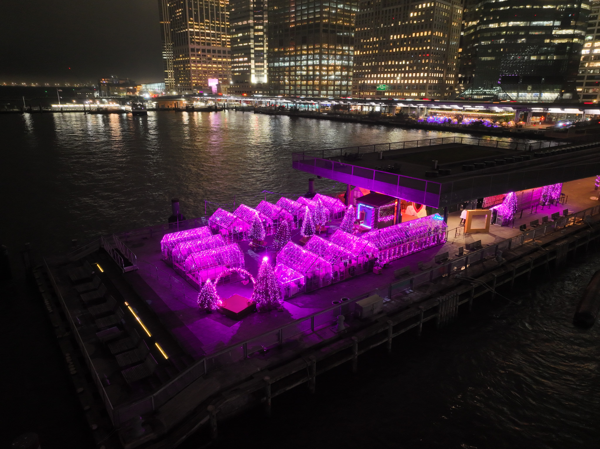 Drone view of Pink Pier at Watermark with pink-themed seating and skyline views