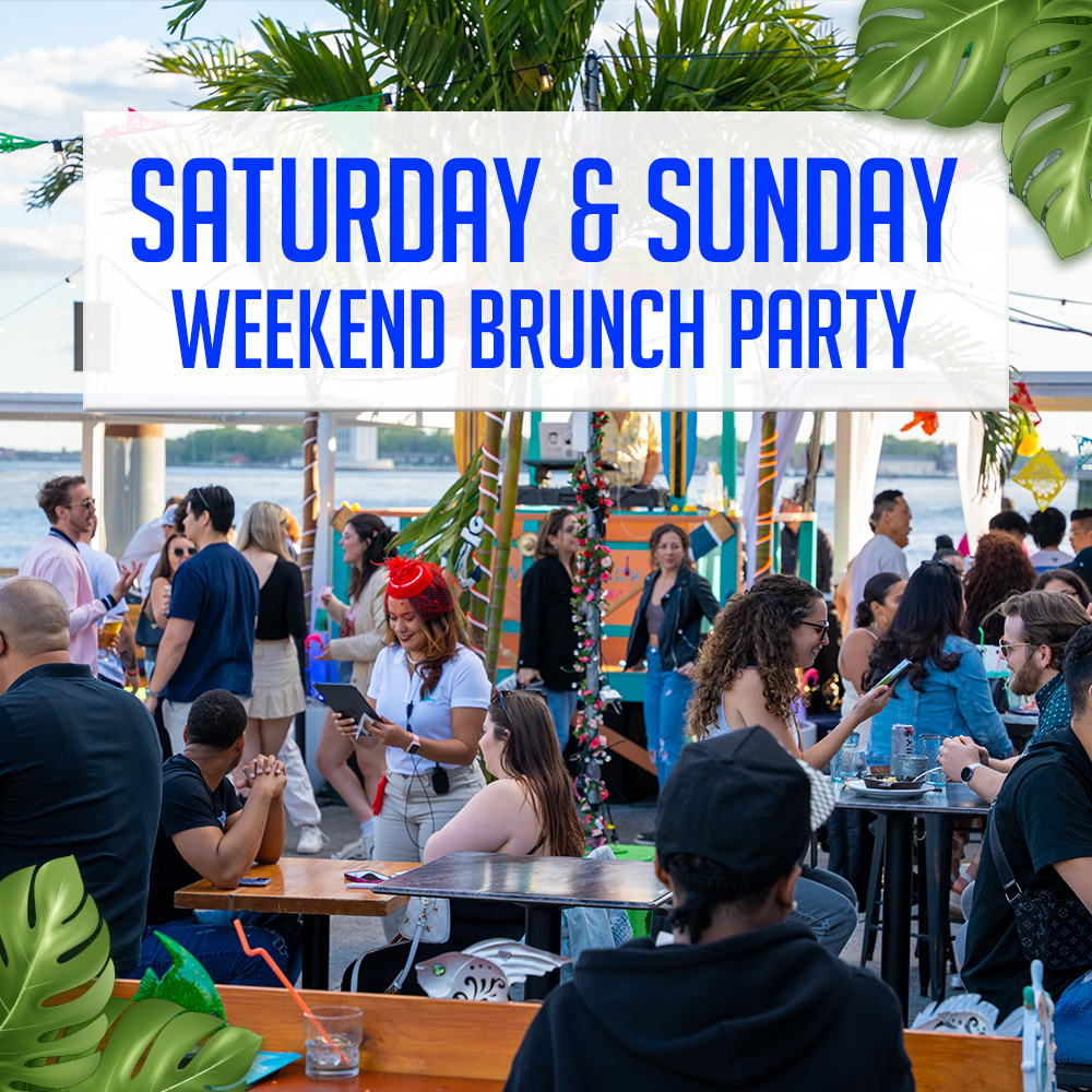 Guests enjoying brunch on a sunny outdoor patio with waterfront views