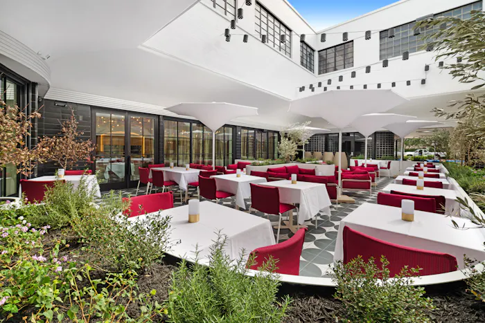 The shaded patio with sofas and tables