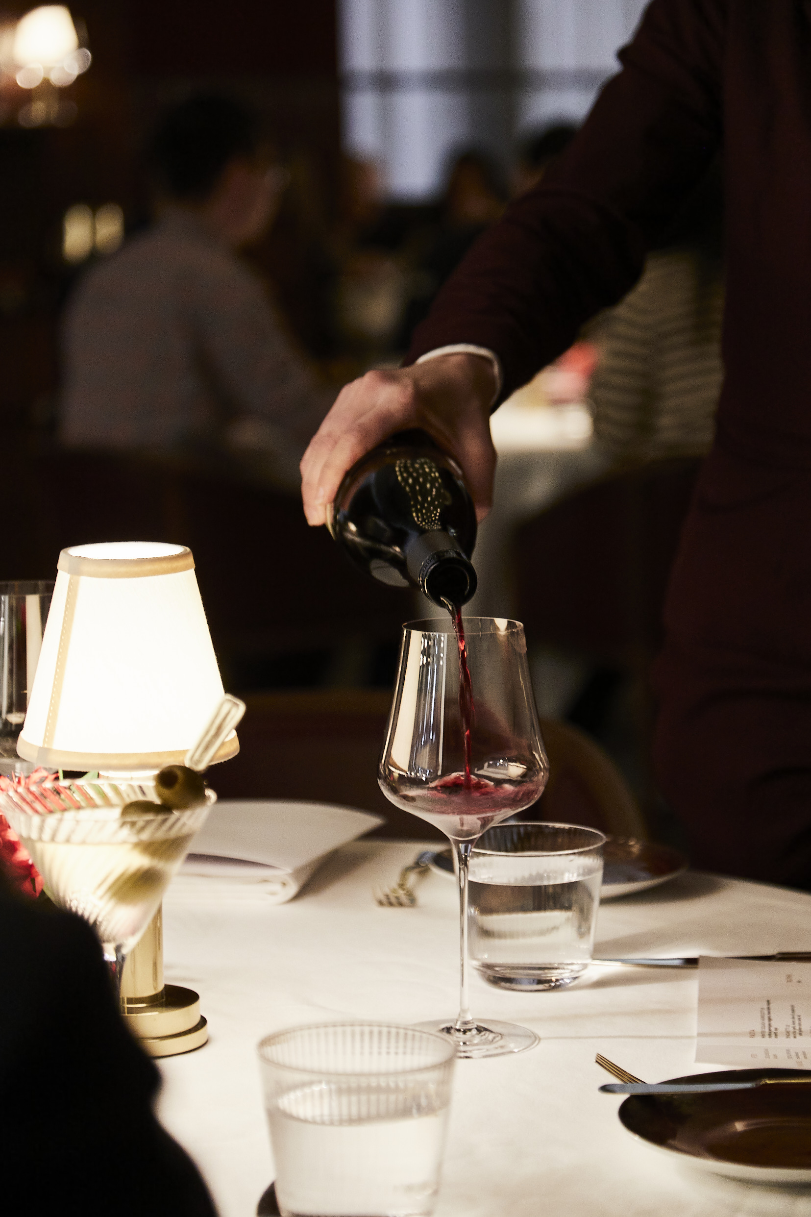a person sitting at a table with a cake