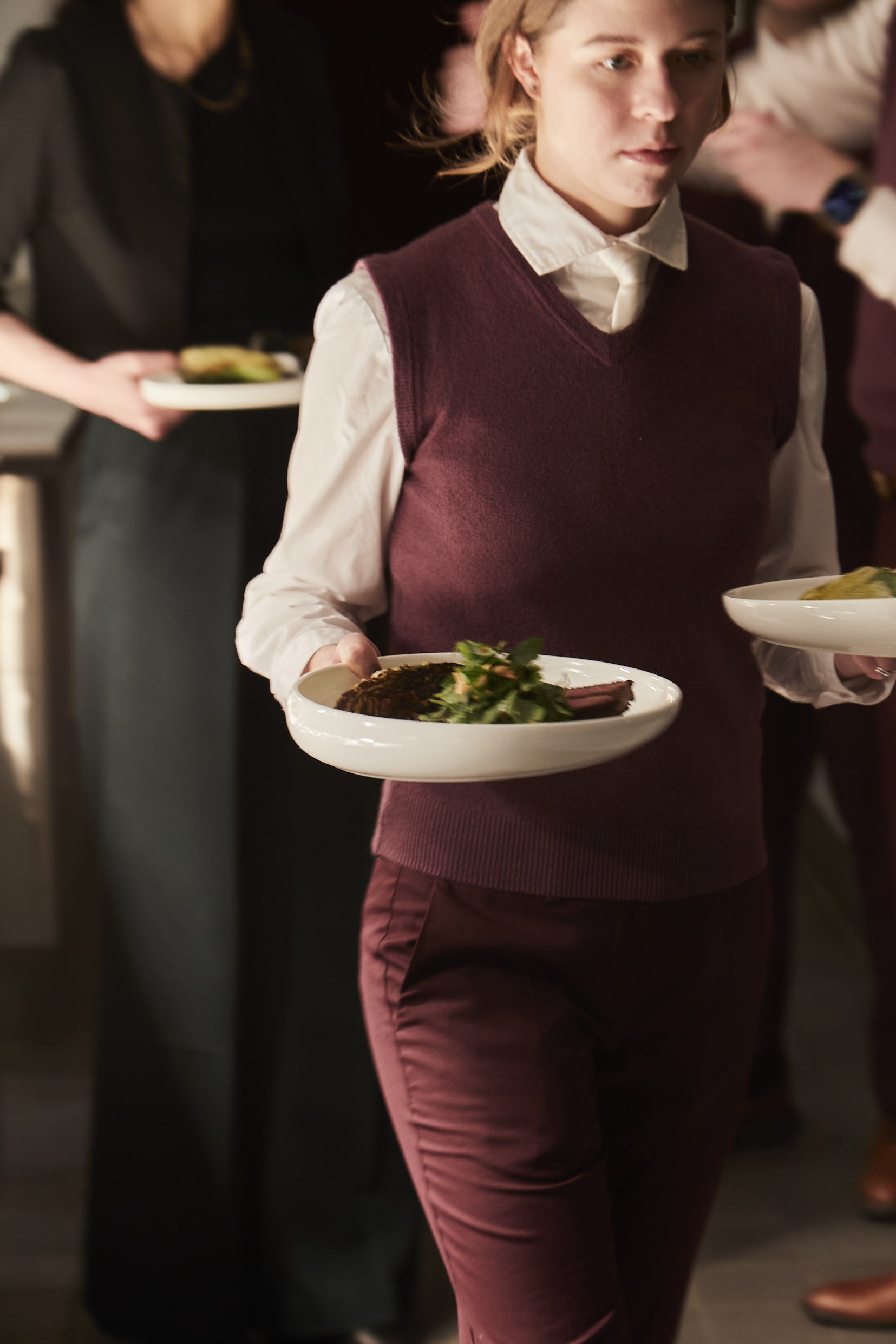 a woman sitting at a table with a plate of food