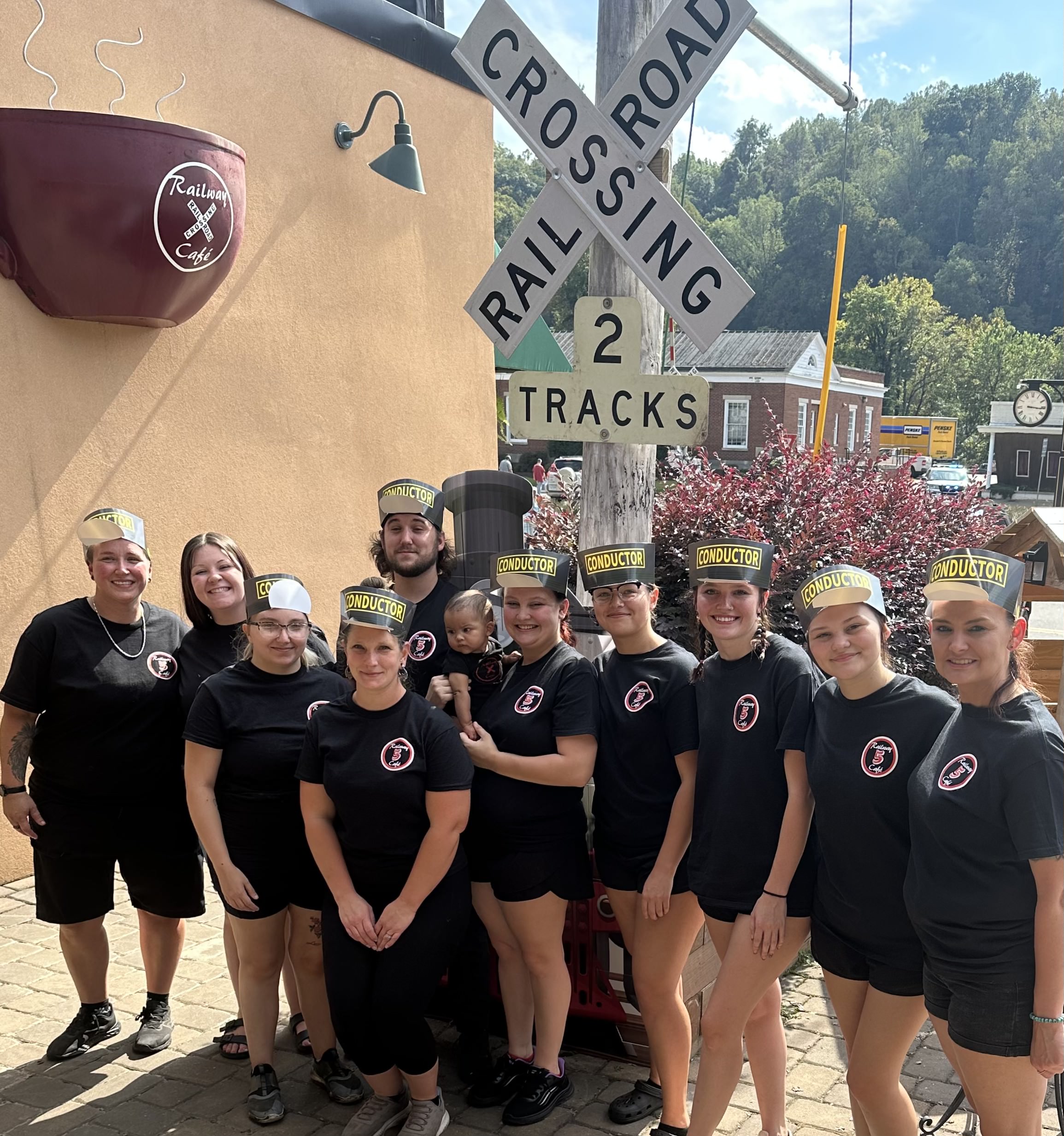 a group of people standing in front of a crowd posing for the camera