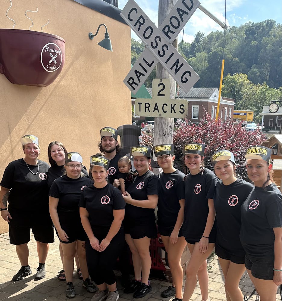 a group of people standing in front of a crowd posing for the camera