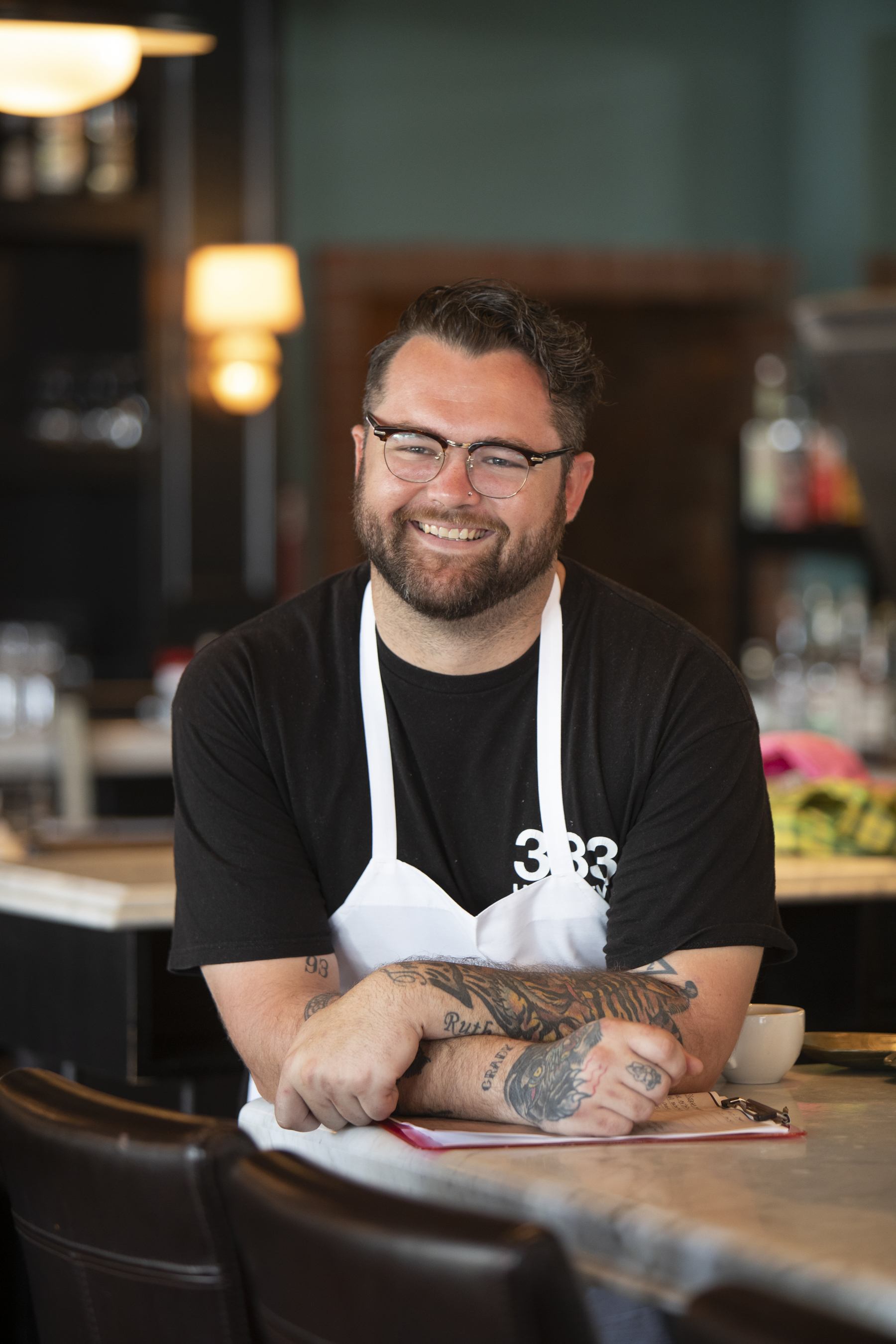a man sitting at a table using a laptop