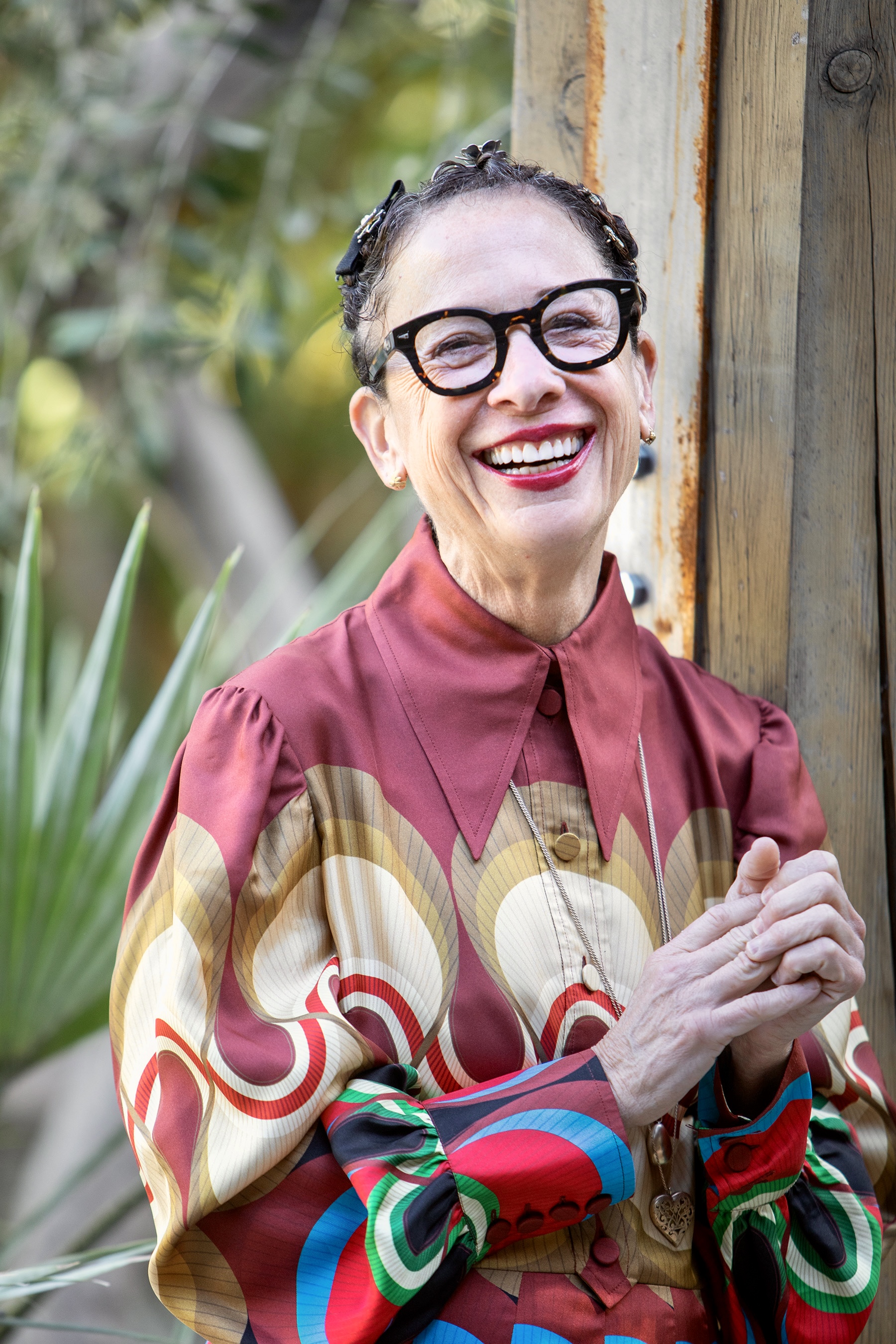 a woman smiling with glasses