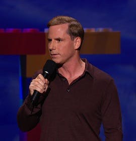 Tom Cotter holding a microphone