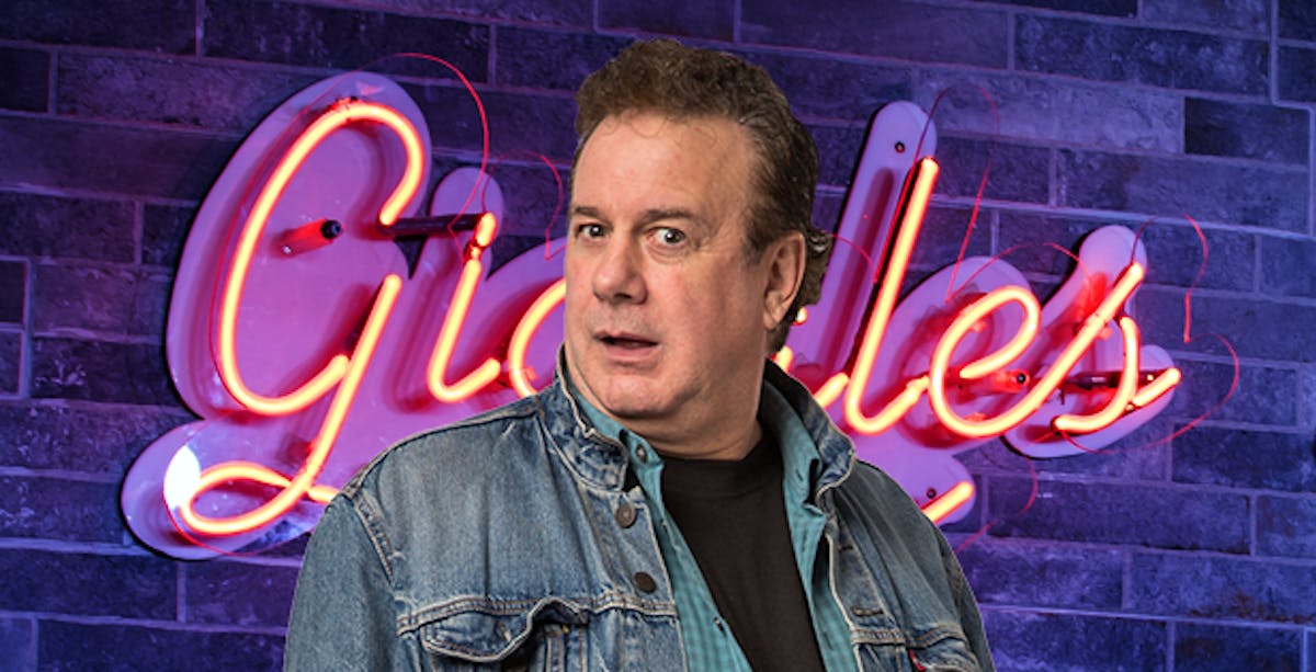 Ken Rogerson standing in front of a brick building