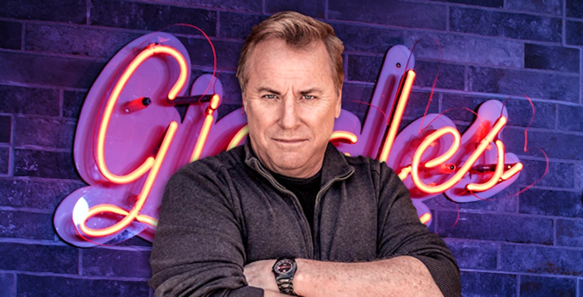 Jimmy Shubert sitting in front of a brick wall