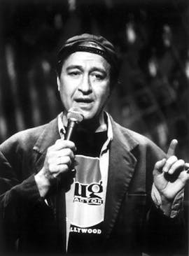 a man holding a phone up to his mouth