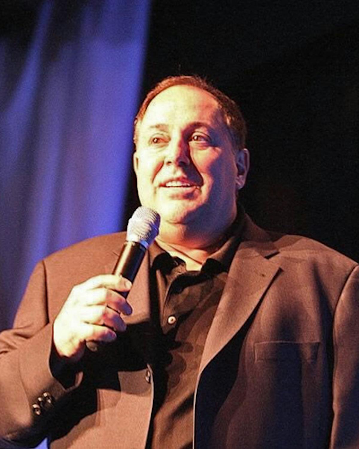 Richie Minervini holding a microphone