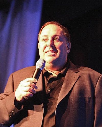 Richie Minervini holding a microphone