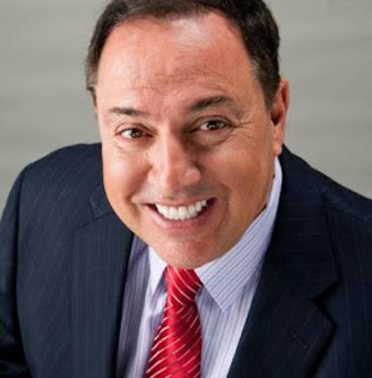 Richie Minervini wearing a suit and tie