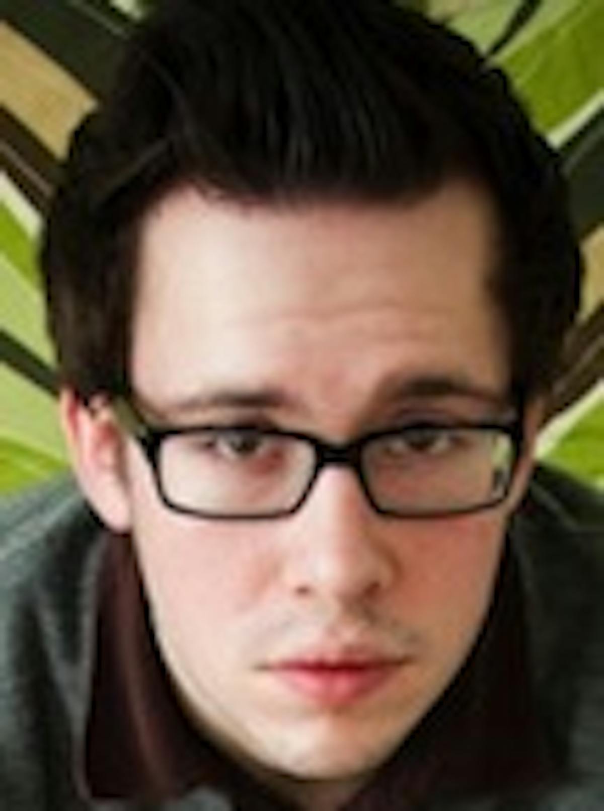 a man wearing glasses and looking at the camera