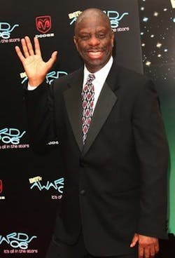 Jimmie Walker wearing a suit and tie