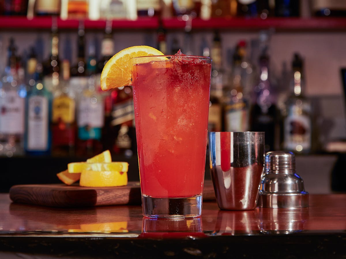 a bottle and a glass of orange juice