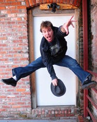 a man doing a trick on a brick building