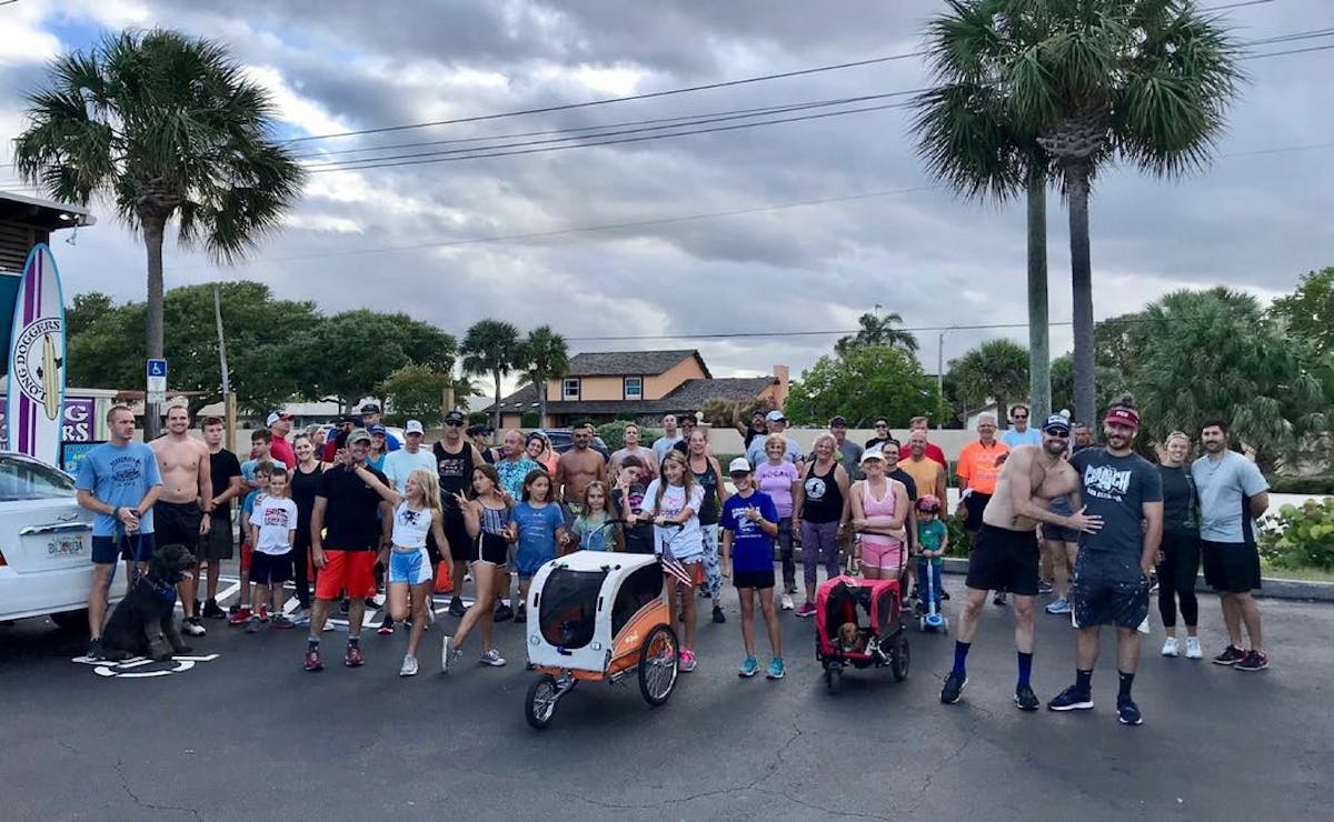 a group of people standing in a parking lot