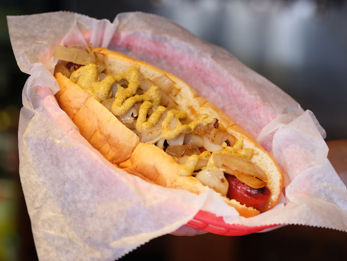 a close up of a hot dog on a bun
