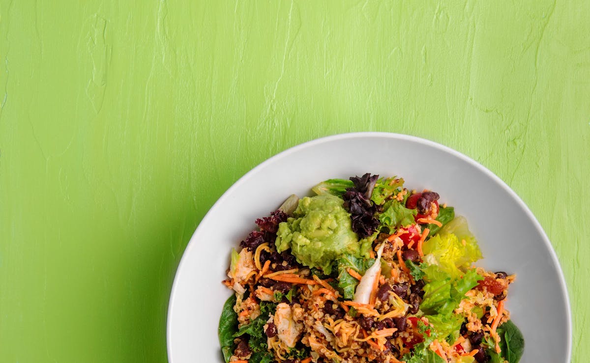 a bowl of salad and protein
