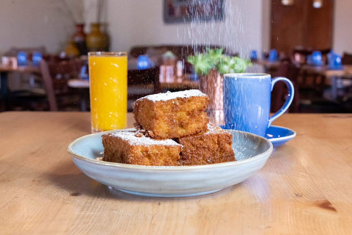 a bowl of food sitting on top of a wooden table