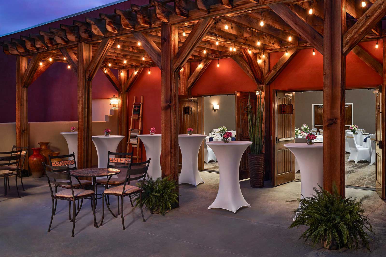 a patio with tables and chairs