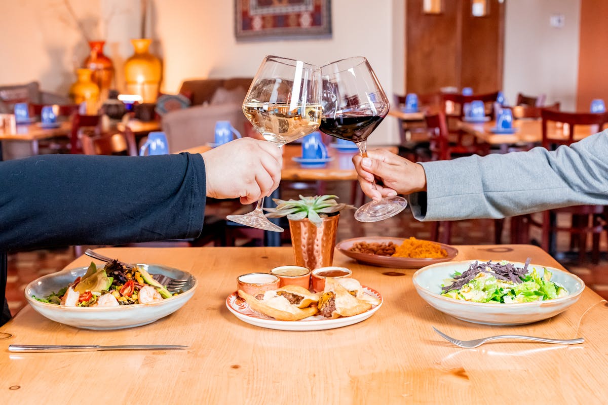 a person sitting at a table with a plate of food