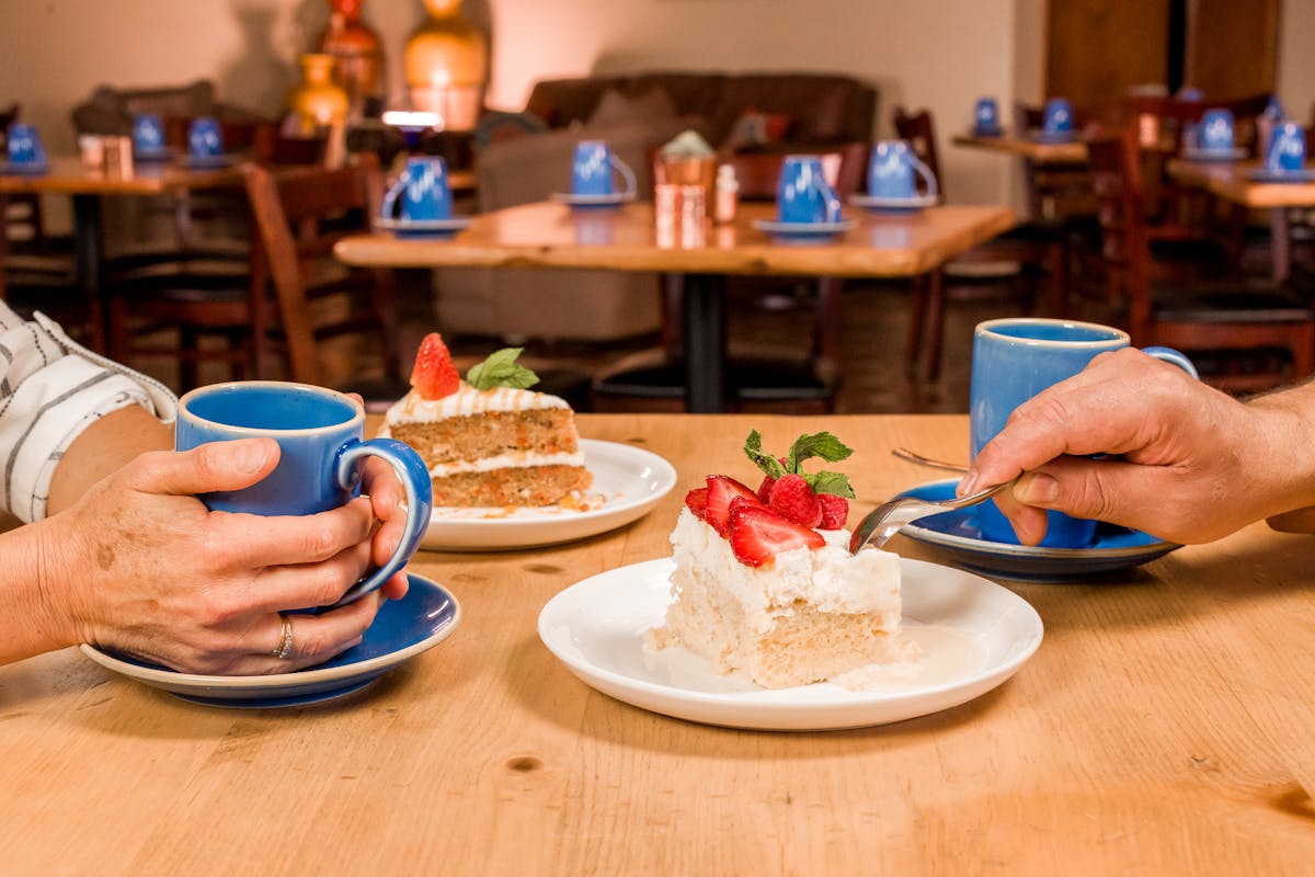 a person sitting at a table with a plate of food