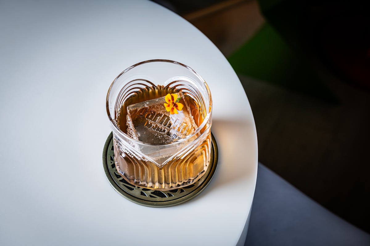 a cocktail sitting on a white table