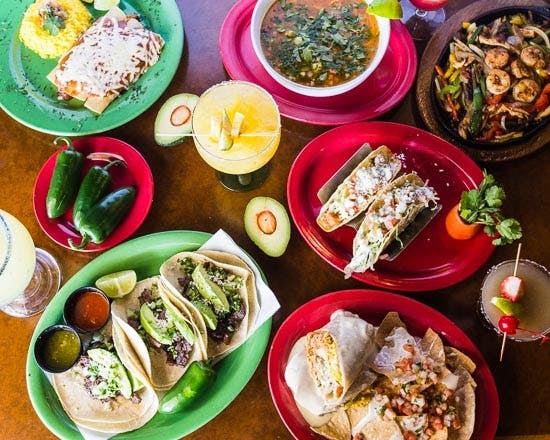 a bunch of food sitting on top of a wooden table