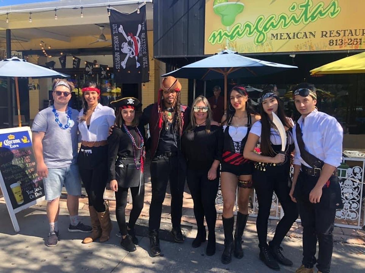 a group of people standing in front of a crowd posing for the camera